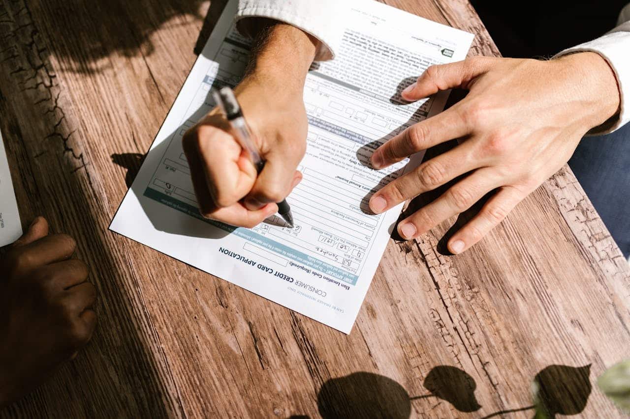 Person writing checklist of questions for immigration translation service Australia